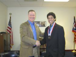 Dwight Global Leadership Academy graduate Nielsen Dias receives Congressional Medal for Service from Congressman Steve Stivers.